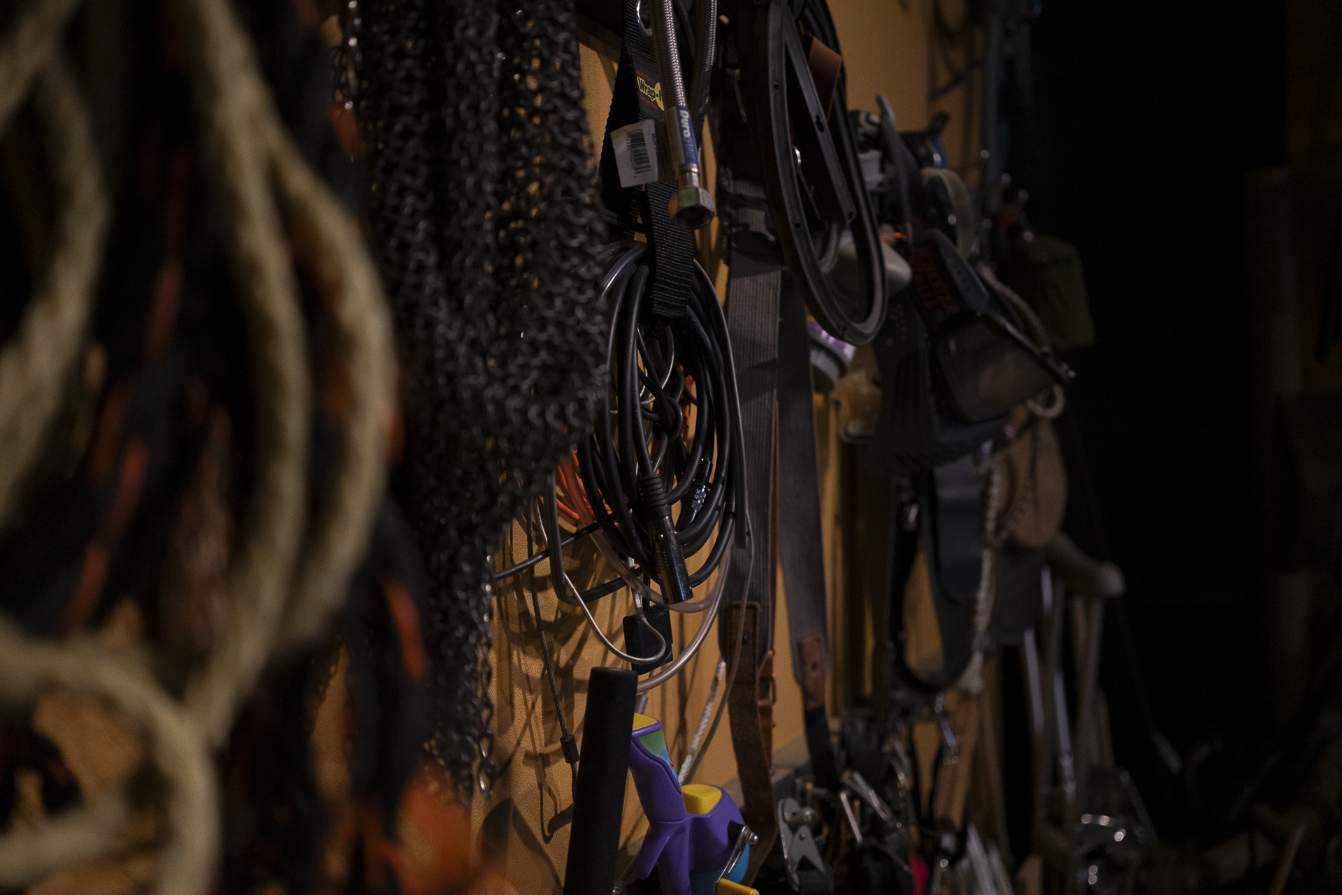 Ropes, straps and gear hung on the prop room wall