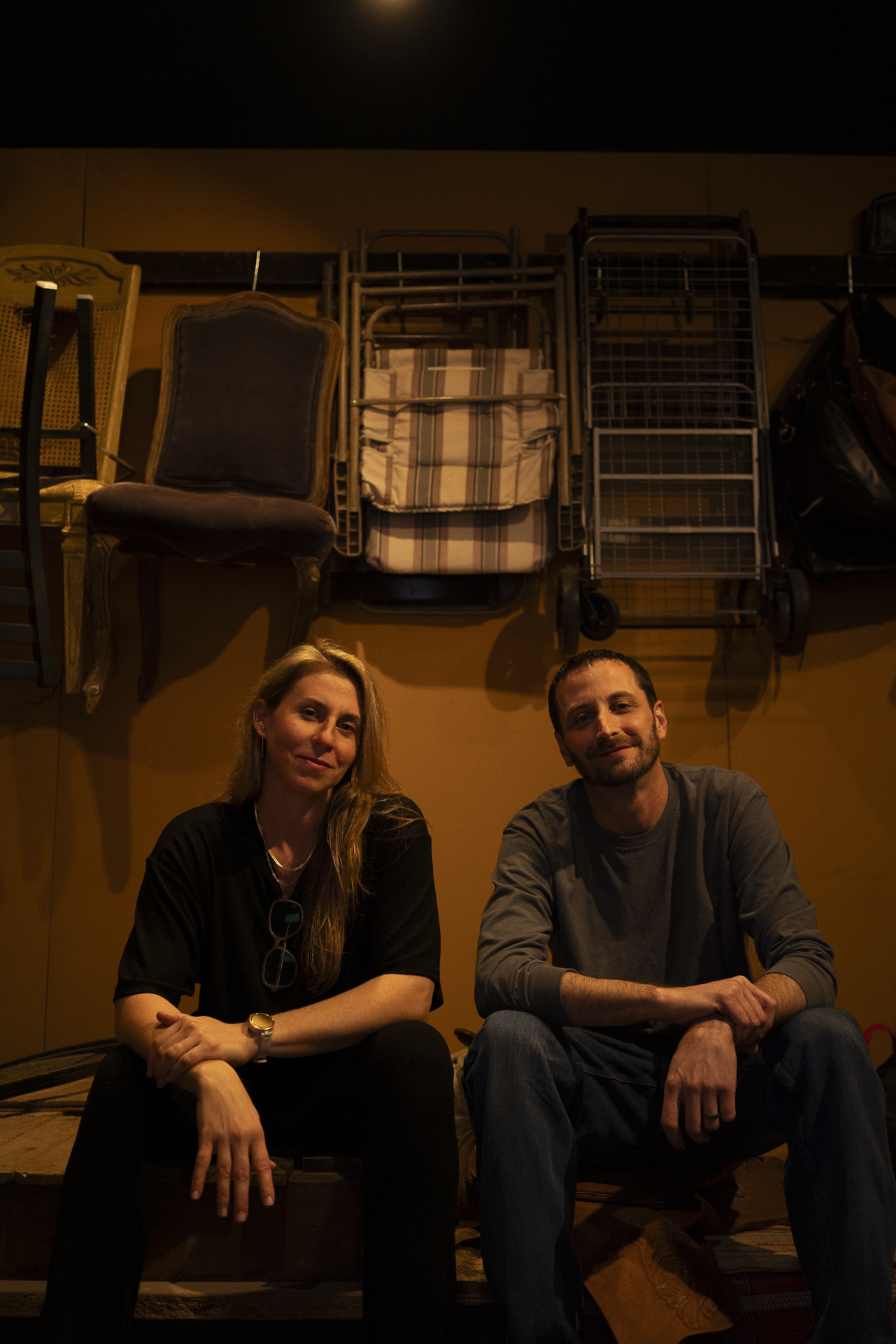 Tara Blume and Ryan Maguire seated in the Foley prop room at The Foley Job in Burbank, California