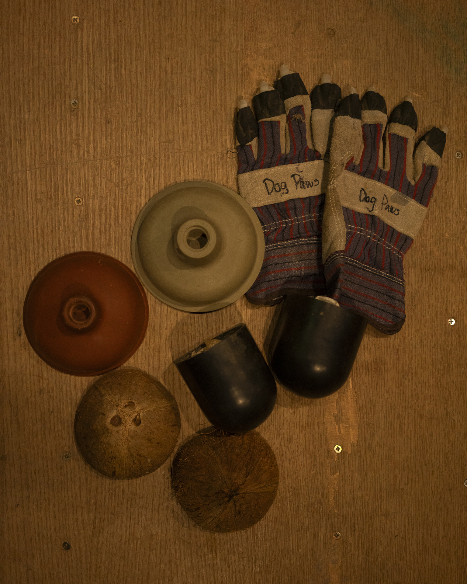 Flat lay of hand props — gloves, tins and lids